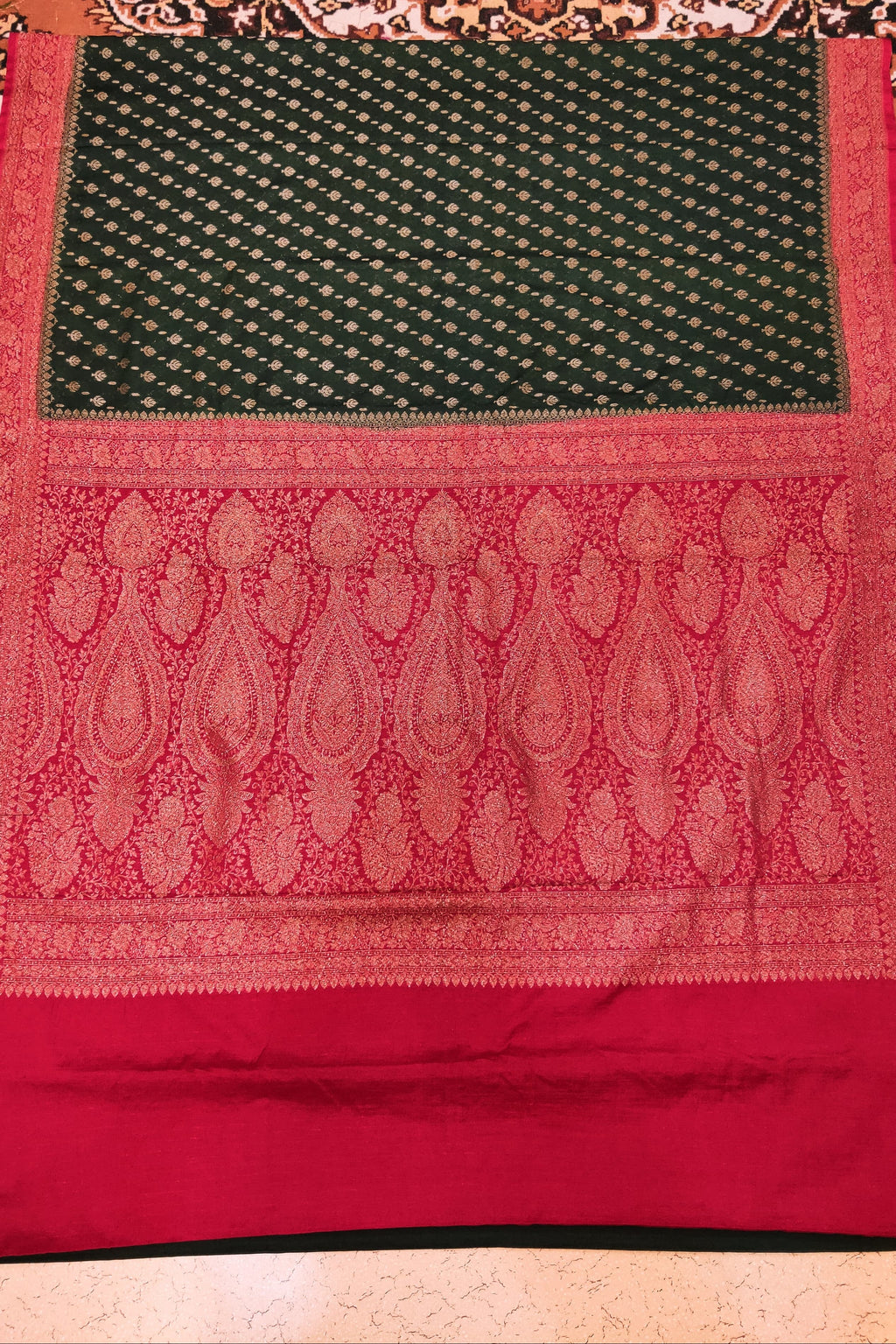 Red and green patterned fabric on a textured surface