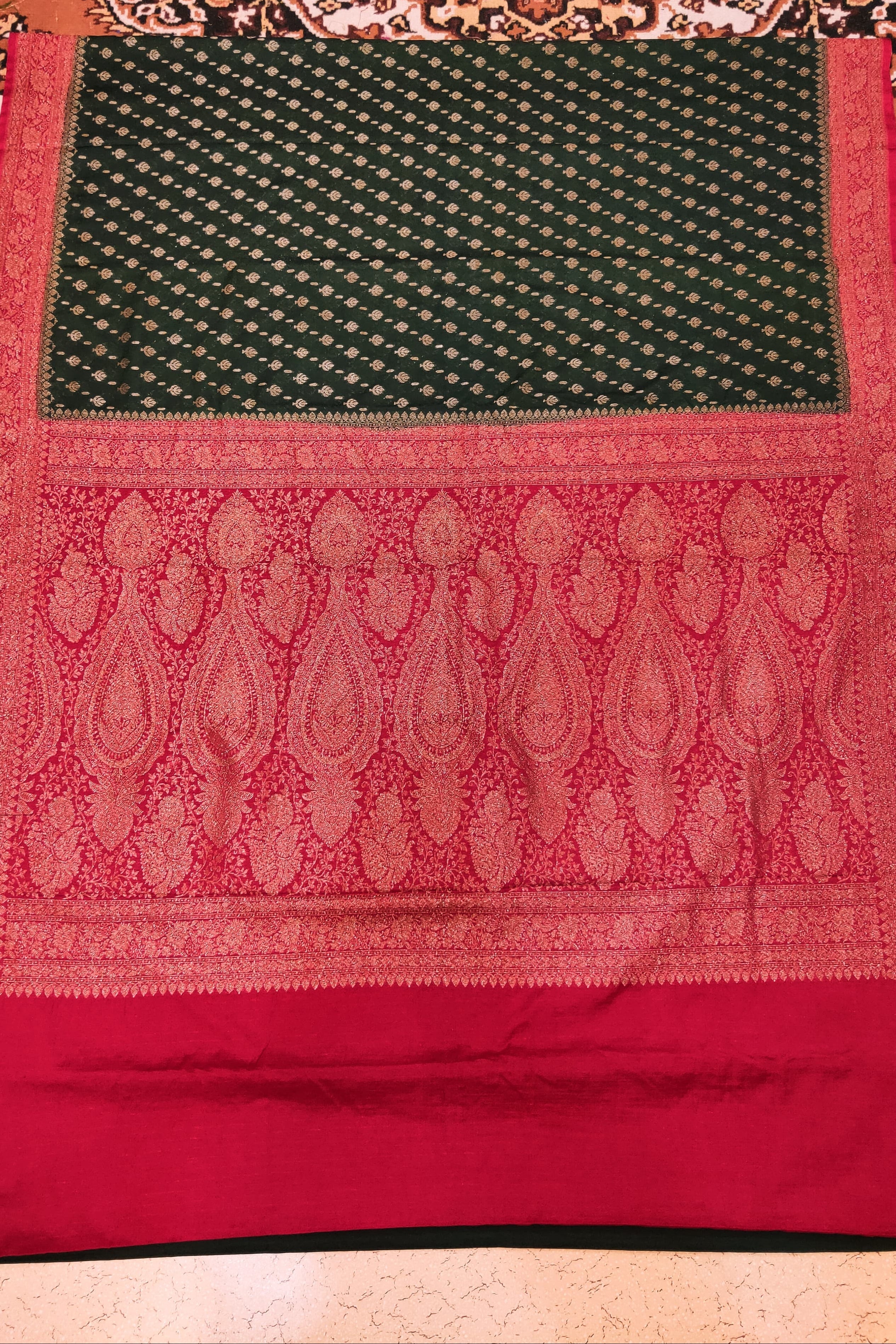 Red and green patterned fabric on a textured surface