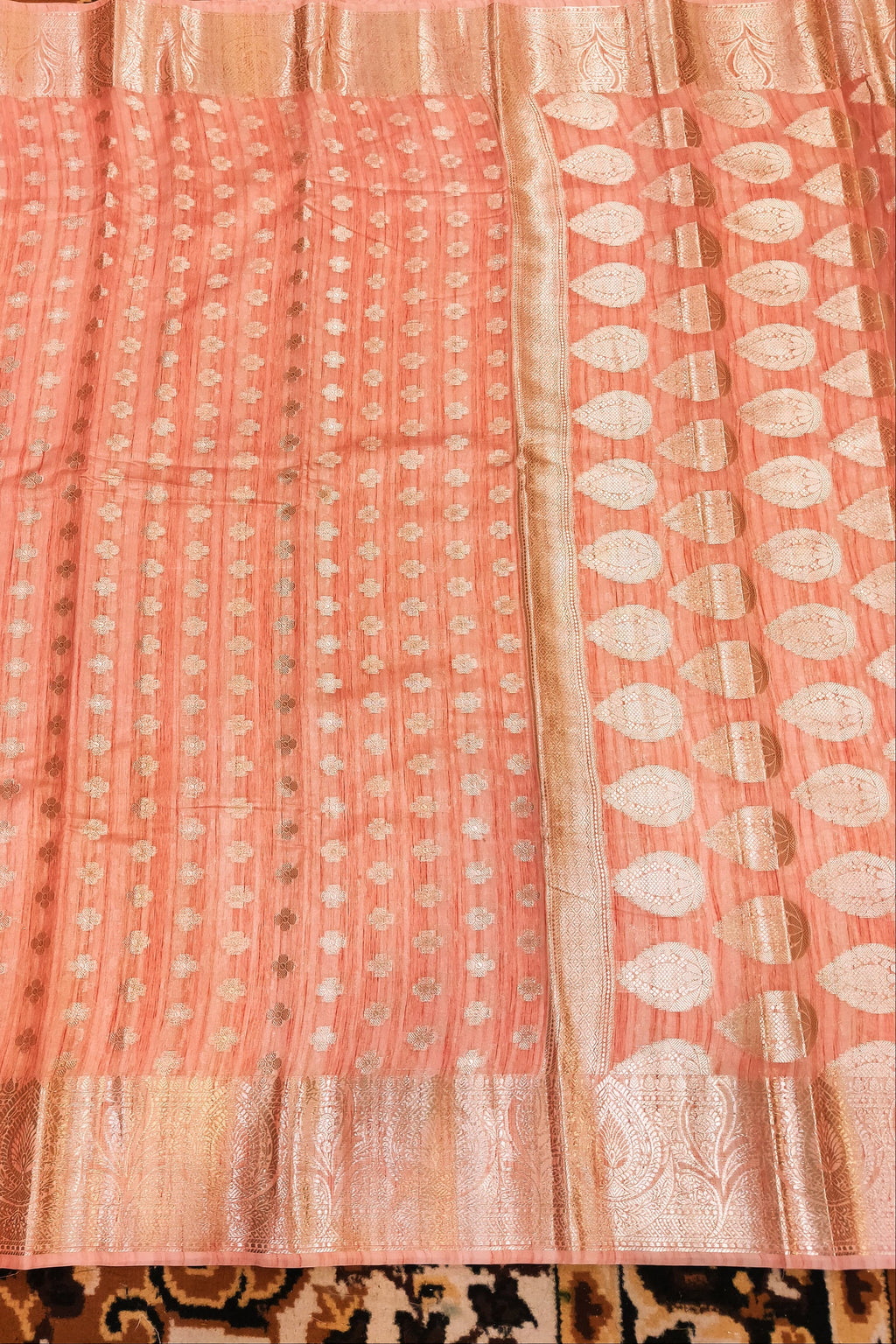 Pink fabric with white patterns on a patterned background